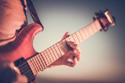 Close-up of hand playing guitar