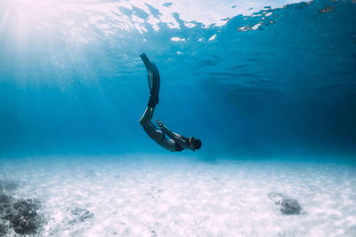 Low section of woman swimming in sea