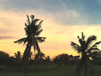 Silhouette palm trees against sky during sunset