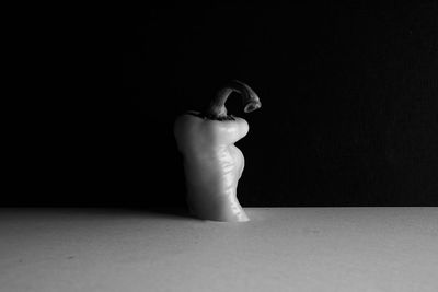 Midsection of woman standing against black background