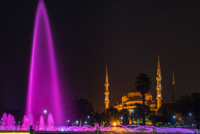 Night cityscape of sultanahmet square with illuminated fountain and blue mosque, istanbul, turkey