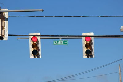 Low angle view of road signs against sky