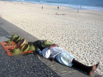 Low section of woman sitting on beach