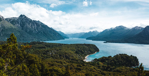 Scenic view of river amidst mountains against sky