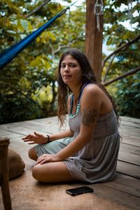 Young woman sitting outdoors