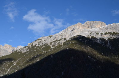 Low angle view of mountain against blue sky