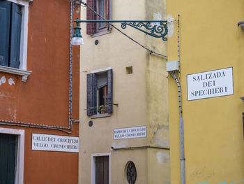Typical alleyway of venice with the names of the roads on the wall