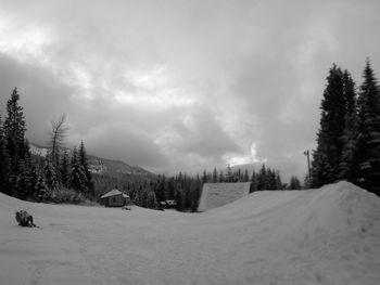 Scenic view of snow covered field against sky