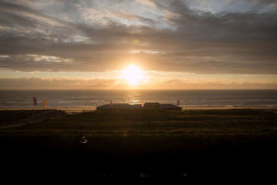 Scenic view of beach against sky during sunset