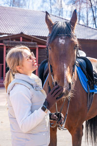 Rear view of woman riding horse