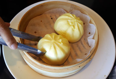 Close-up of person preparing food in plate