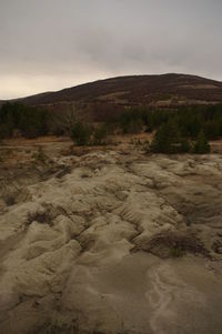 Scenic view of sand dunes against sky