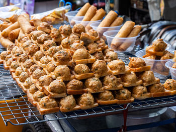 Fried bread with minced pork spread for sale at a local street food market in bangkok, thailand.