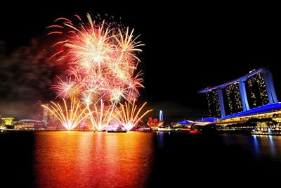 Firework display over river at night