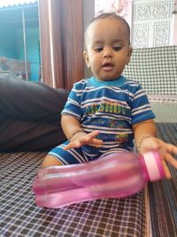 Cute girl looking away while sitting at home