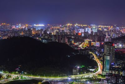 Aerial view of illuminated buildings against clear sky