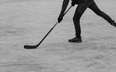 Low section of man playing ice hockey