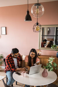 Female friends sitting at home