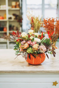Diy autumn flower arrangement bouquet in pumpkin at floristry studio