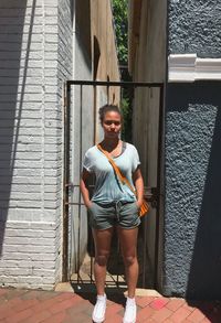 Portrait of girl standing against door