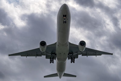 Low angle view of airplane against sky