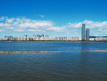 Scenic view of sea and buildings against sky