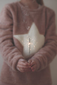 Close-up of girl holding sparkler