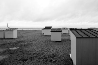 Lifeguard hut on beach against sky