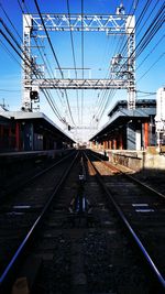 Train at railroad station platform against sky