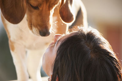 Close-up of woman playing with dog