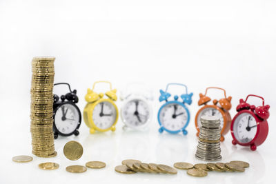 Close-up of coins on table against white background