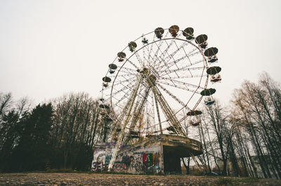 Low angle view of ferris wheel against sky