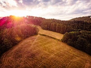 Scenic view of field against sky during sunset