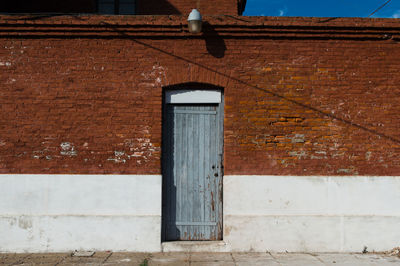 Low section of person against door of building