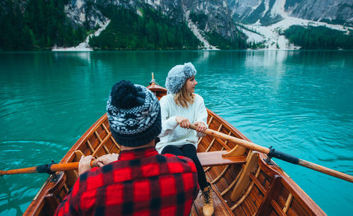 Friends sitting on boat in lake