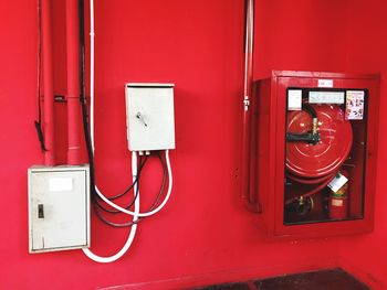 Close-up of red telephone booth against wall