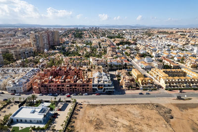 High angle view of buildings in city against sky