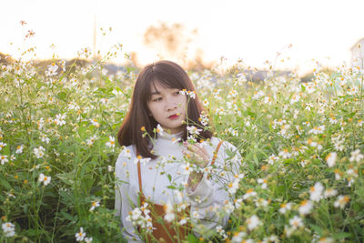 Portrait of mature woman on field against sky