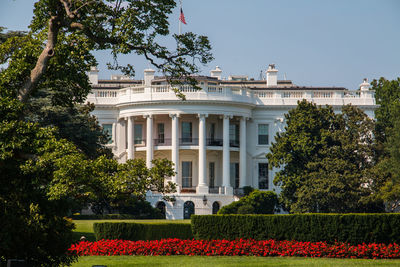 White house in front of lawn against sky