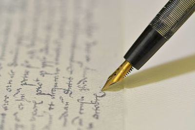 Fountain pen on a blurred letter background. old fountain pen on an vintage handwritten letter. 