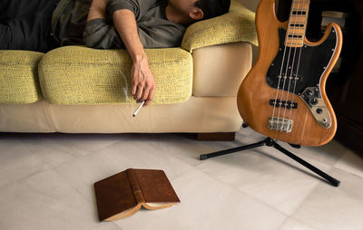 Man playing guitar on sofa