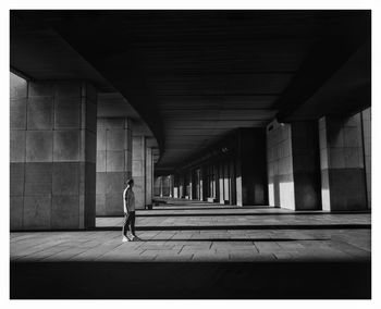 Full length of man standing in empty corridor