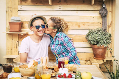 Smiling woman with vegetables on cutting board