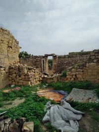 Ruins of building against cloudy sky