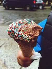 Close-up of hand holding ice cream cone