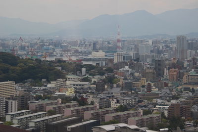 High angle view of buildings in city against sky