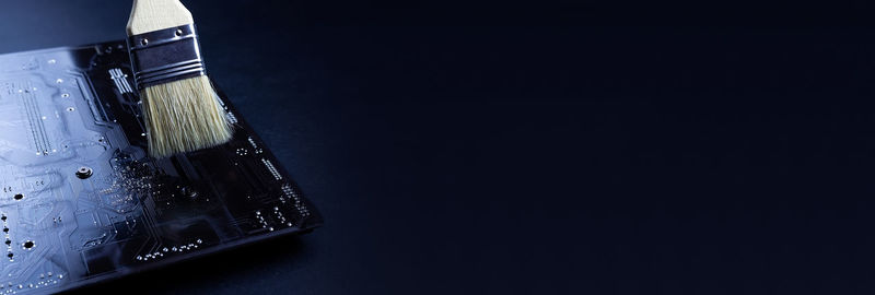 High angle view of electric lamp on table against black background