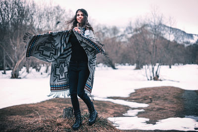 Woman standing on field during winter