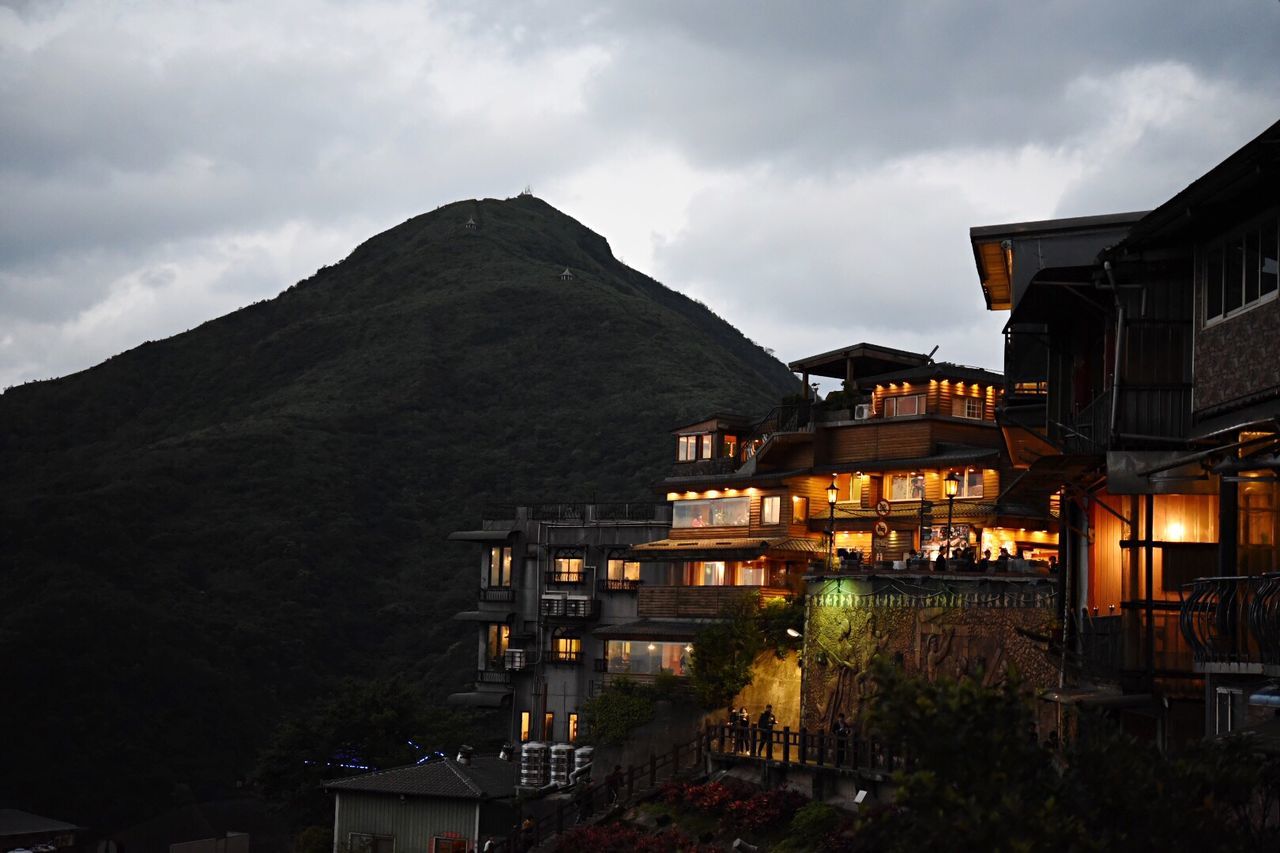 building exterior, architecture, built structure, sky, cloud - sky, mountain, outdoors, illuminated, no people, nature, night, residential building, tree, beauty in nature