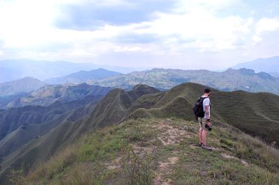 Full length of man standing on mountain against sky